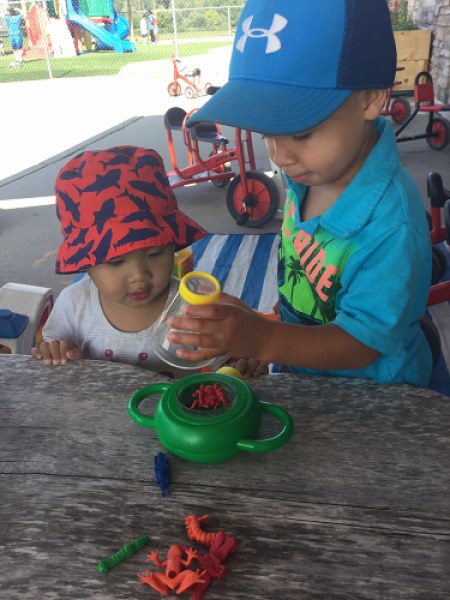 children catching pretend bugs